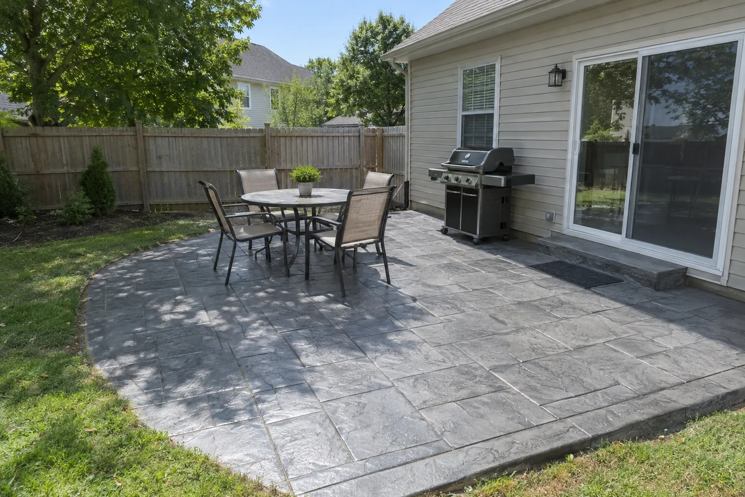 Gray ashlar slate stamped concrete patio behind a home in Clarksville, TN